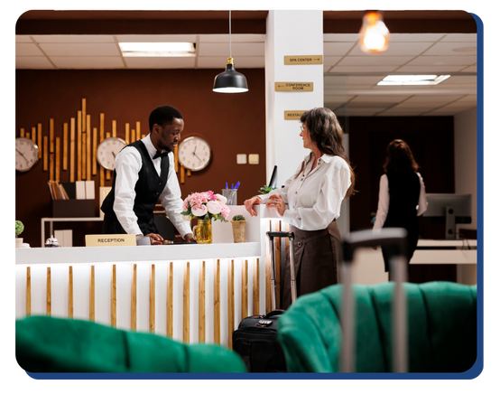 Hotel receptionist assisting a guest at a modern, clean front desk with organized decor, ensuring a warm and sanitary welcome experience. Hotel receptionist assisting a guest at a modern, clean front desk with organized decor, ensuring a warm and sanitary welcome experience.