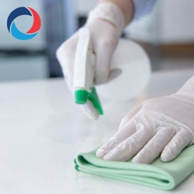 Close-up of a cleaning professional using a spray bottle and cloth, highlighting reliable cleaning services in Burlington by Impact Commercial Cleaning Company.