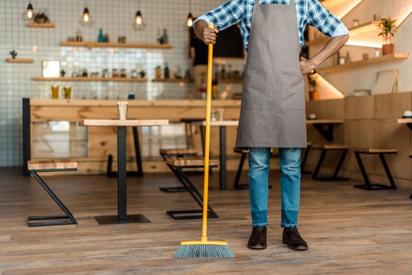 cropped view of worker cleaning restaurant