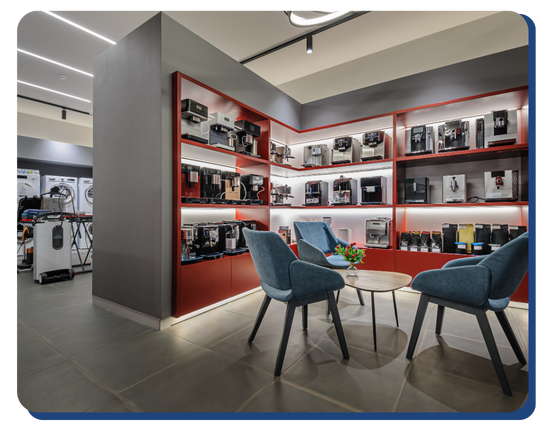 A modern electronics retail showroom with sparkling clean shelves and seating area, highlighting professional retail cleaning services.