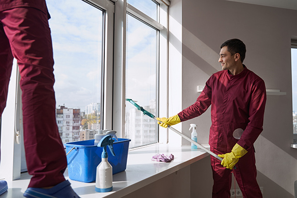Professional cleaners washing windows and sanitizing surfaces in a Toronto apartment or condo. Professional cleaners washing windows and sanitizing surfaces in a Toronto apartment or condo.