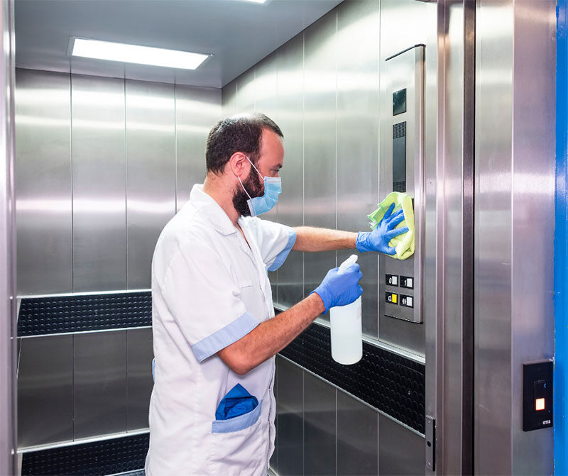 man cleaning an elevator