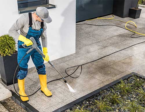 Expert applying protective sealant on commercial concrete surface.