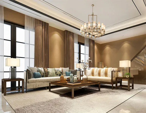 Modern living room with beige walls, two sofas with decorative pillows, a large rug, wooden coffee tables with vases, tall windows with curtains, table lamps, and a chandelier—perfectly maintained by Impact Commercial Cleaning Services.